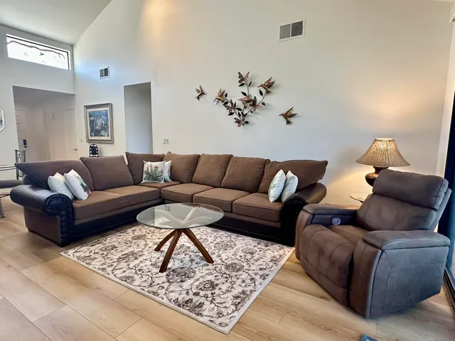 a living room with furniture and painting on the wall
