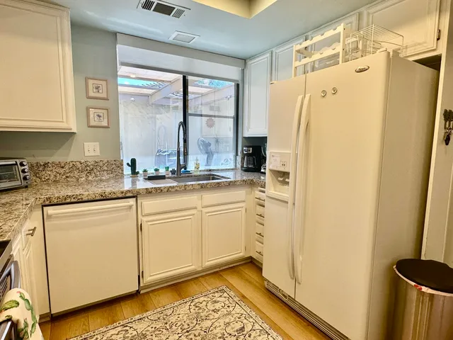 a kitchen with stainless steel appliances a refrigerator sink and cabinets