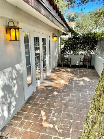 a view of a house with a patio and a yard