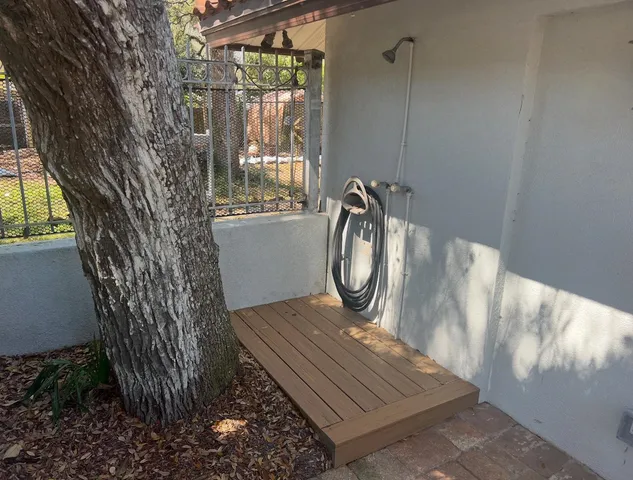 a view of a door and chair in wooden floor