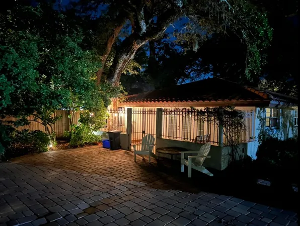 a view of a backyard with sitting area