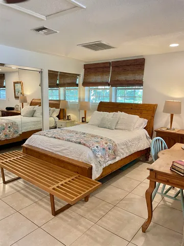 a bedroom with a bed and a mirror