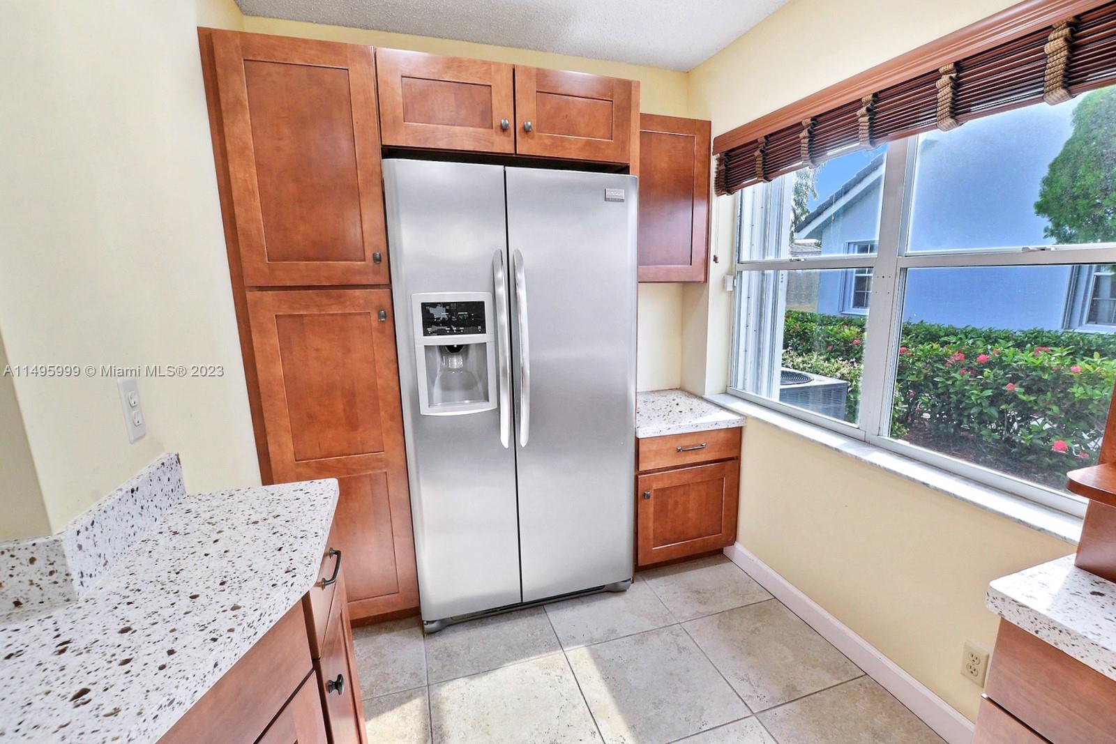 Forest Ridge Cluster Homes Davie, FL 33328 - Photo 20 of 39 a kitchen with stainless steel appliances granite countertop a refrigerator and a stove
