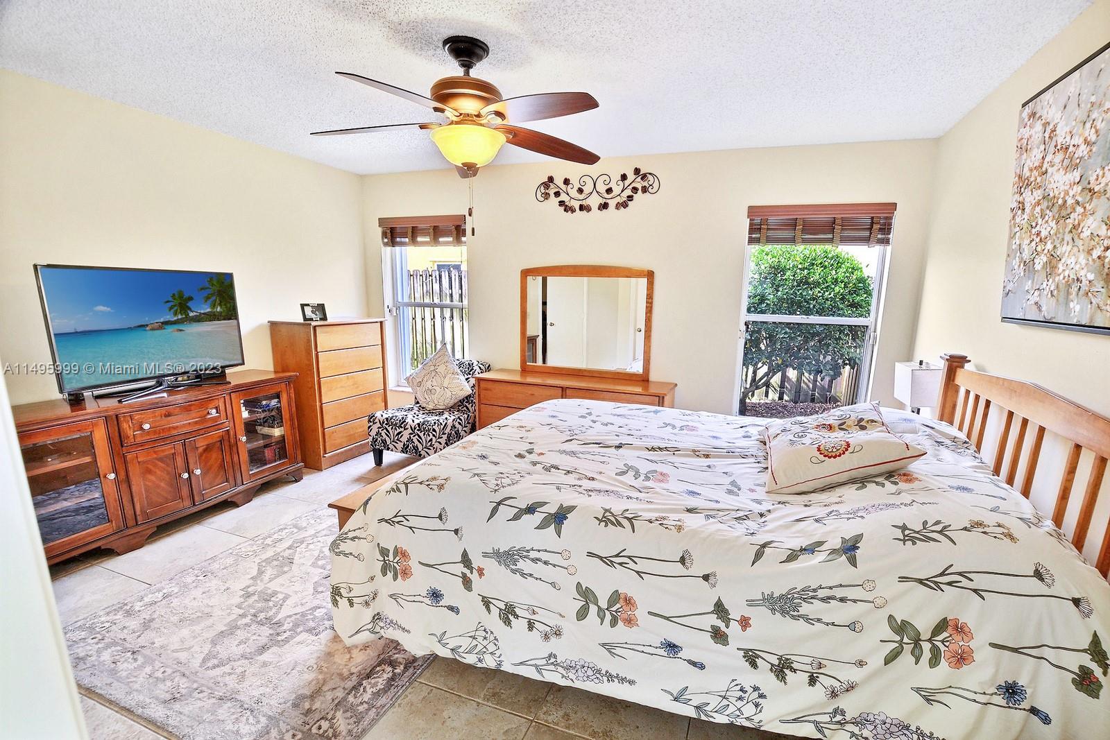 Forest Ridge Cluster Homes Davie, FL 33328 - Photo 22 of 39 a bedroom with a bed and flat screen tv