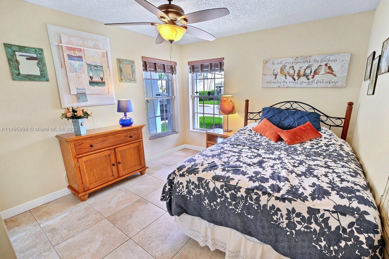 Forest Ridge Cluster Homes Davie, FL 33328 - Photo 26 of 39 a bedroom with a bed and wooden floor