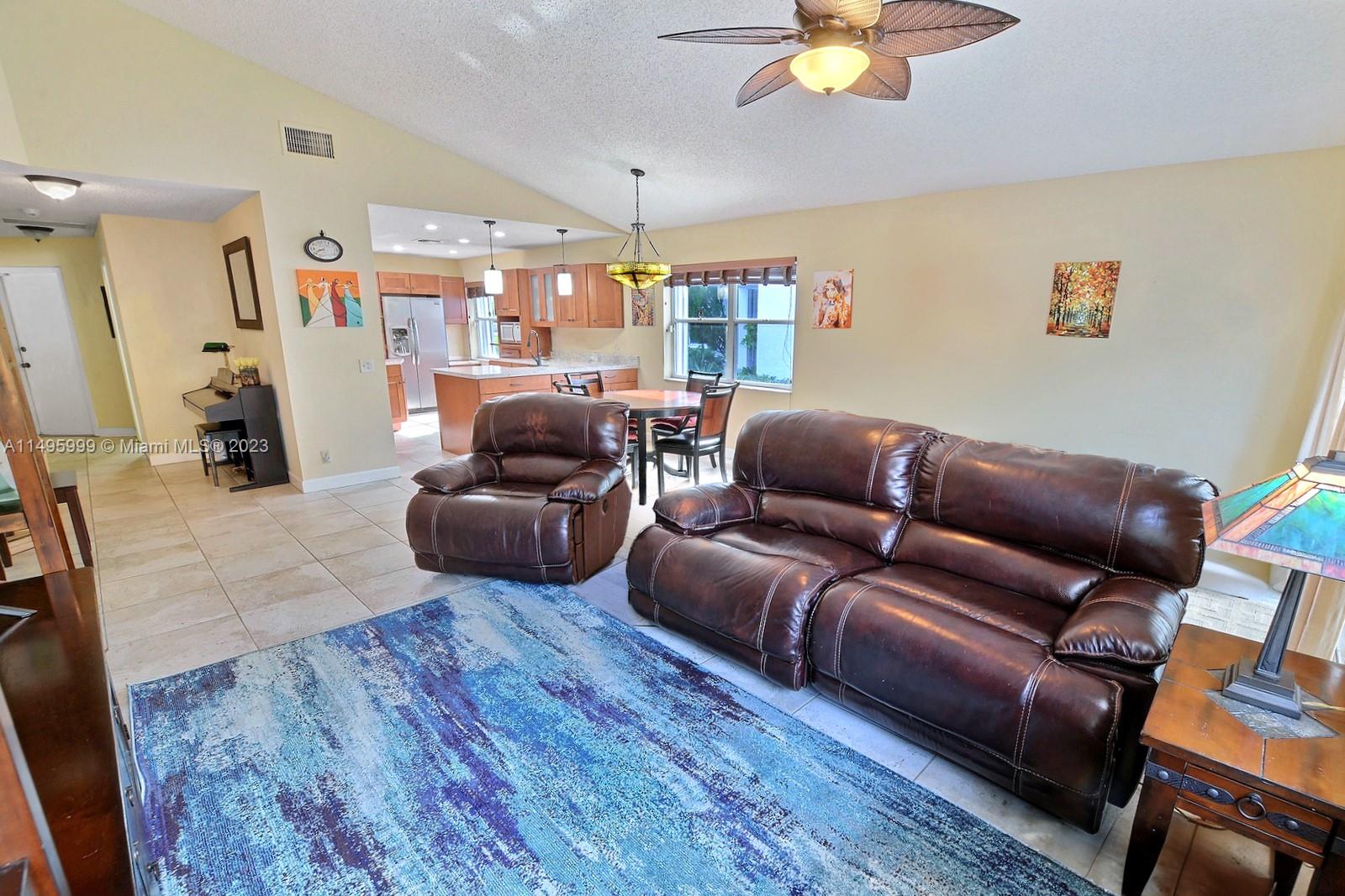 Forest Ridge Cluster Homes Davie, FL 33328 - Photo 10 of 39 a living room with furniture and a chandelier