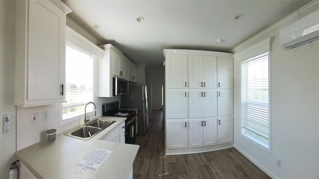 4345 Northwest 27th Place Ocala, FL 34475 - Photo 17 of 39 a kitchen with a refrigerator a sink and wooden cabinets