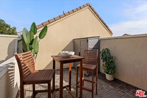 a view of outdoor space with a table and chairs