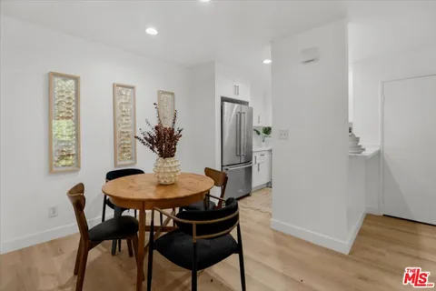 a dining room with furniture and wooden floor