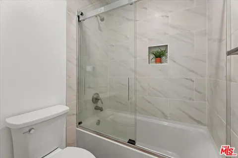 a bathroom with a shower and a toilet