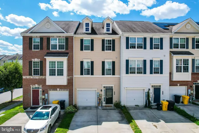 an aerial view of a house with a garden and trees