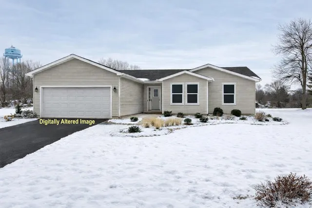 a view of a house with a yard covered in snow