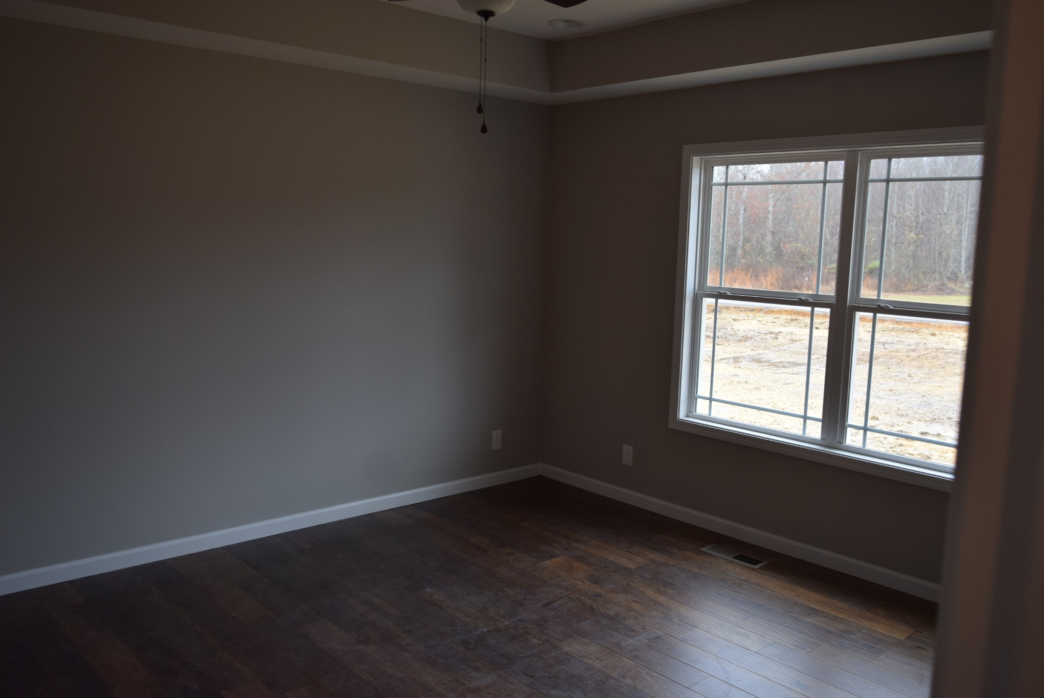 103 Ballard Road Manchester, TN 37355 - Photo 3 of 8 a view of an empty room with wooden floor and a window