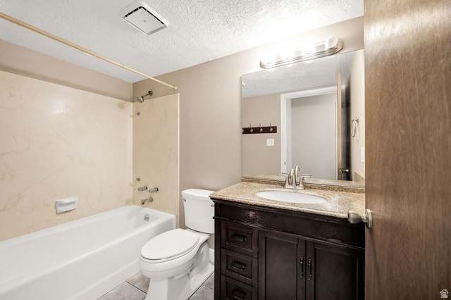 240 East 400 North, Unit 26 Logan, UT 84321 - Photo 9 of 12 Bathroom featuring a dark wood-finish vanity with a light-toned countertop, an integrated sink, and a large wall-mounted mirror