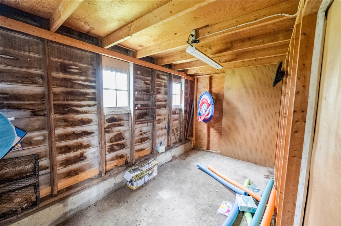 190 Swailes Road Troy, OH 45373 - Photo 75 of 82 This versatile shed offers practical storage solutions with an unfinished interior and exposed wooden beams.
