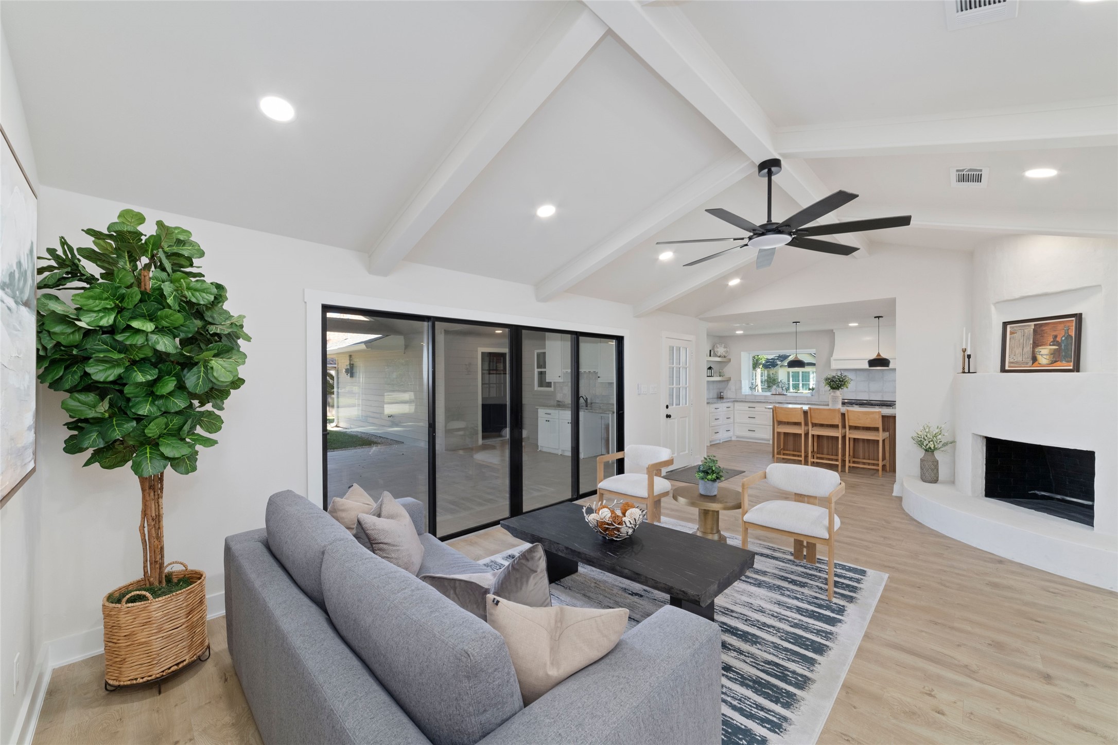 9902 Hornpipe Lane Houston, TX 77080 - Photo 4 of 30 Family Room looking into the kitchen and outdoor patio. The plastered fireplace anchors the room.
