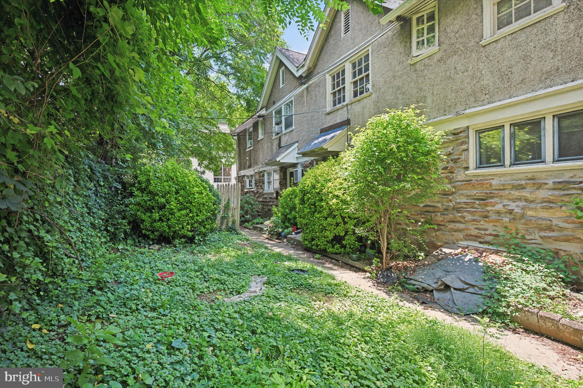 14 Rock Hill Road Bala Cynwyd, PA 19004 - Photo 15 of 15 a view of a brick house with a yard and potted plants