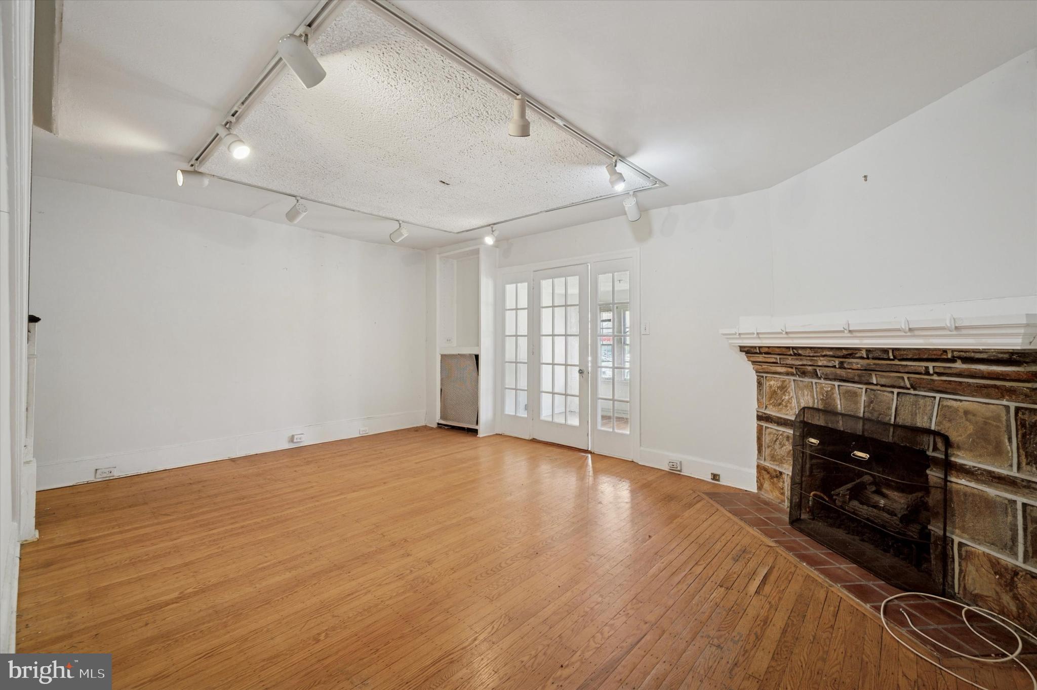 14 Rock Hill Road Bala Cynwyd, PA 19004 - Photo 5 of 15 an empty room with wooden floor fireplace and windows