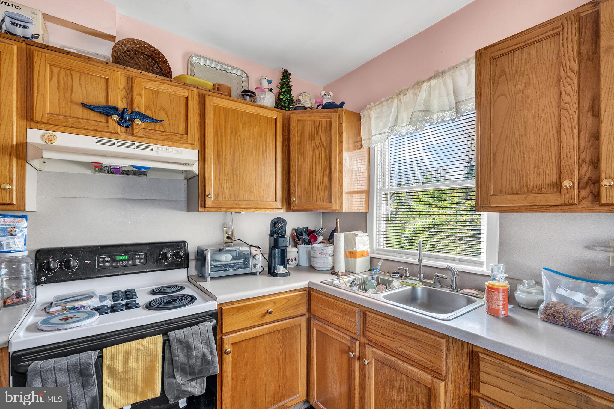 100 Penn Street Penns Grove, NJ 08069 - Photo 11 of 25 a kitchen with stainless steel appliances granite countertop a sink stove and cabinets