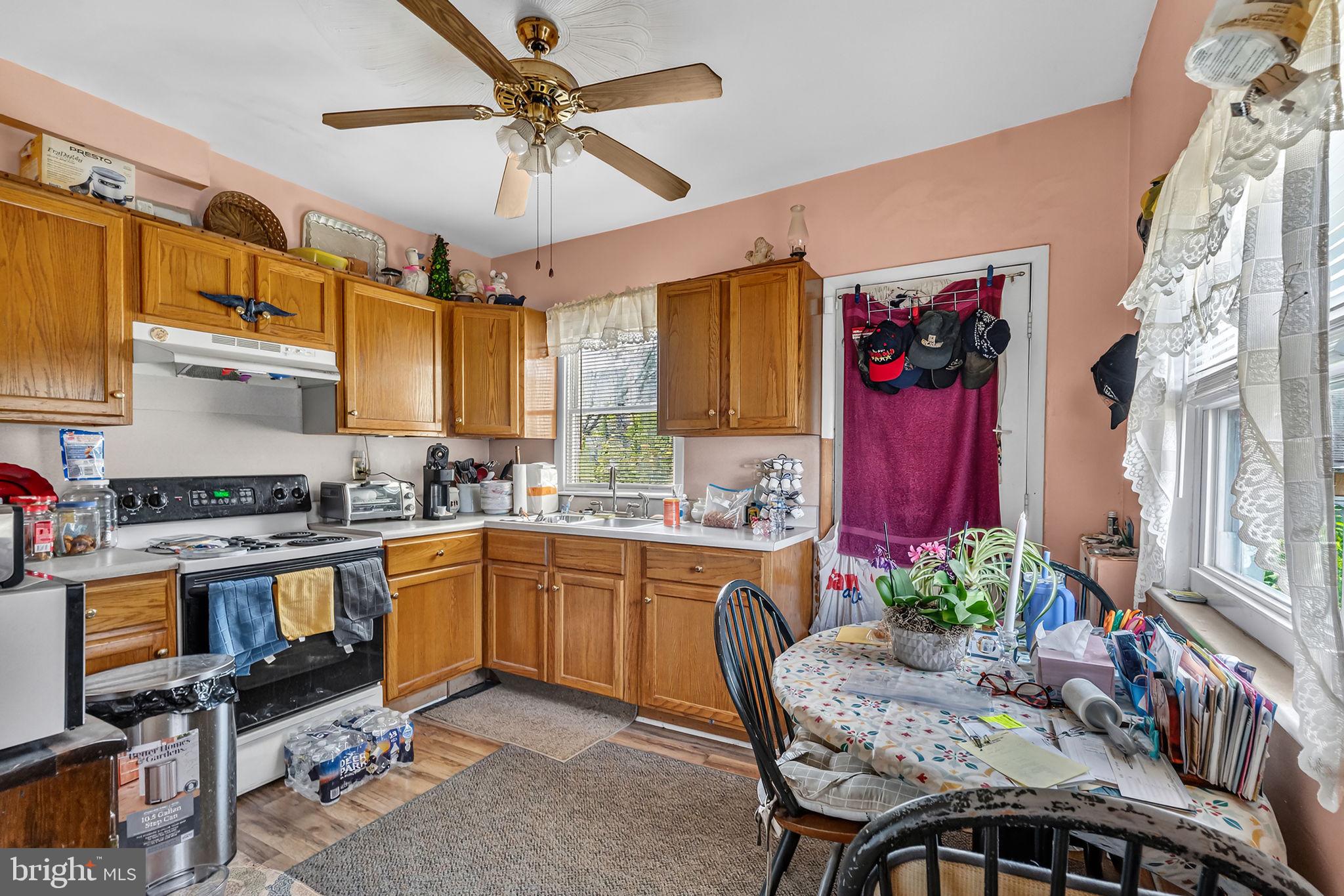 100 Penn Street Penns Grove, NJ 08069 - Photo 8 of 25 a kitchen with a table chairs stove and cabinets