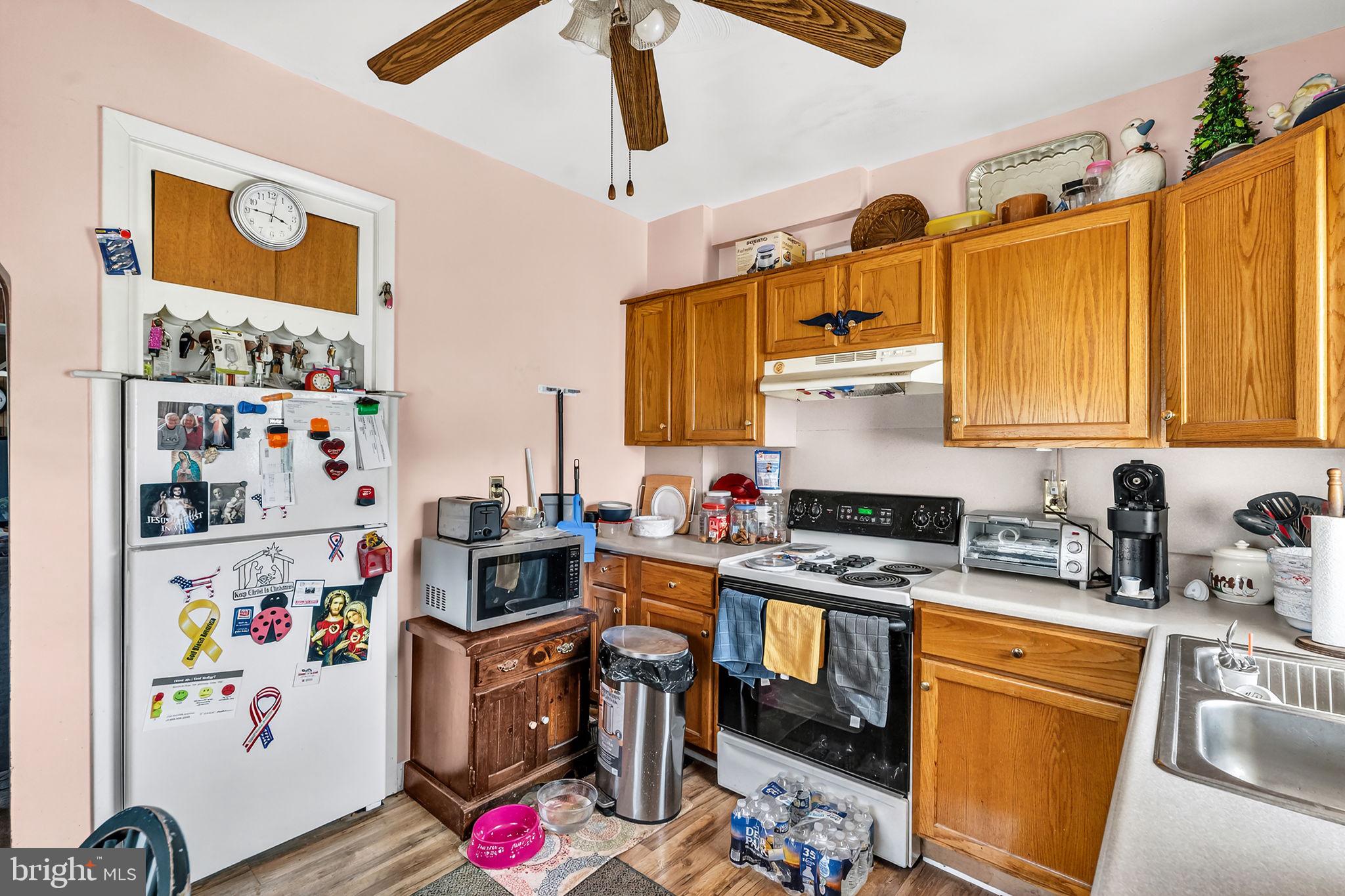 100 Penn Street Penns Grove, NJ 08069 - Photo 9 of 25 a kitchen with stainless steel appliances a stove a sink and a refrigerator