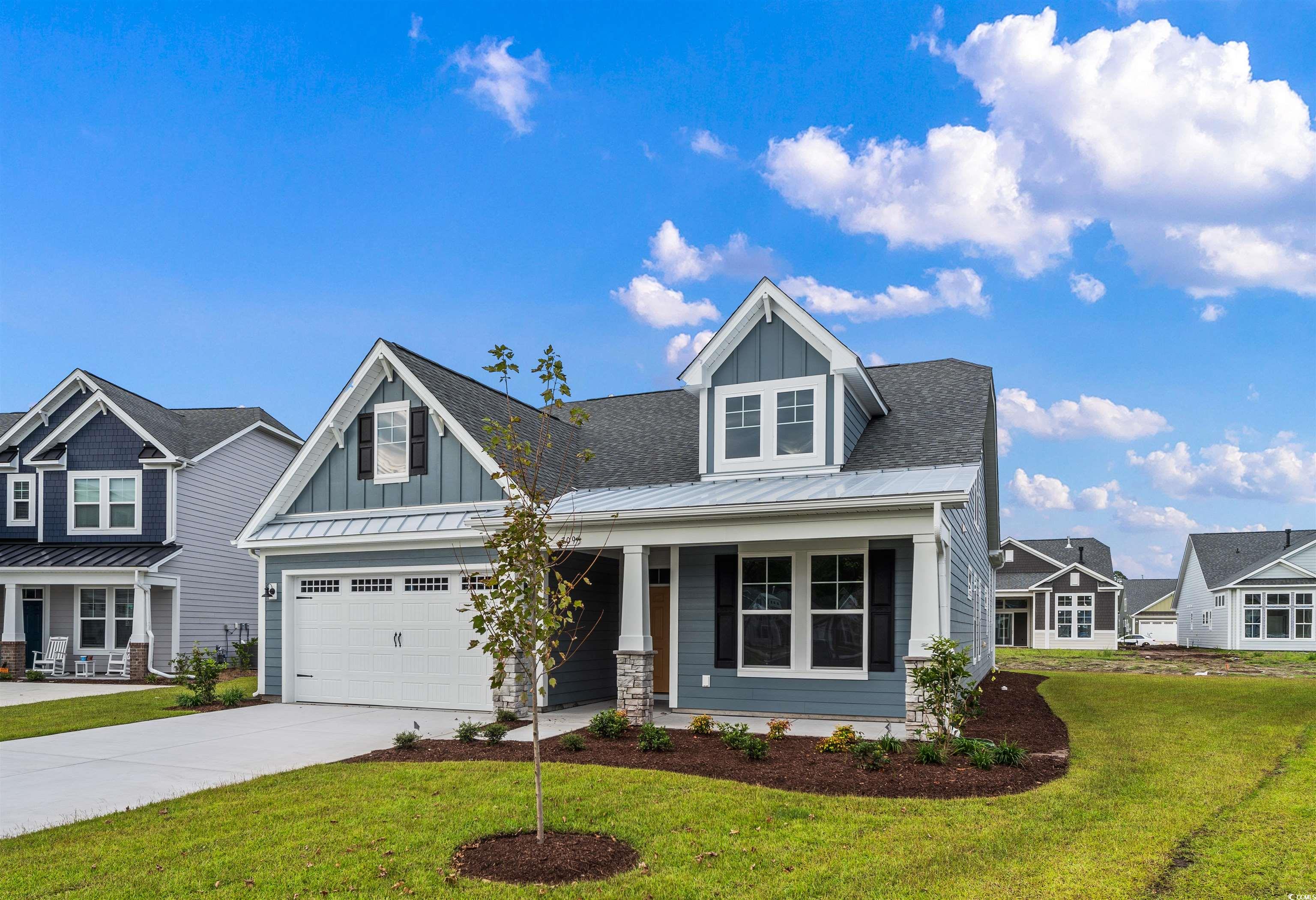 709 Lapwind Loop Myrtle Beach, SC 29579 - Photo 2 of 15 Craftsman-style house featuring a front lawn, a ga