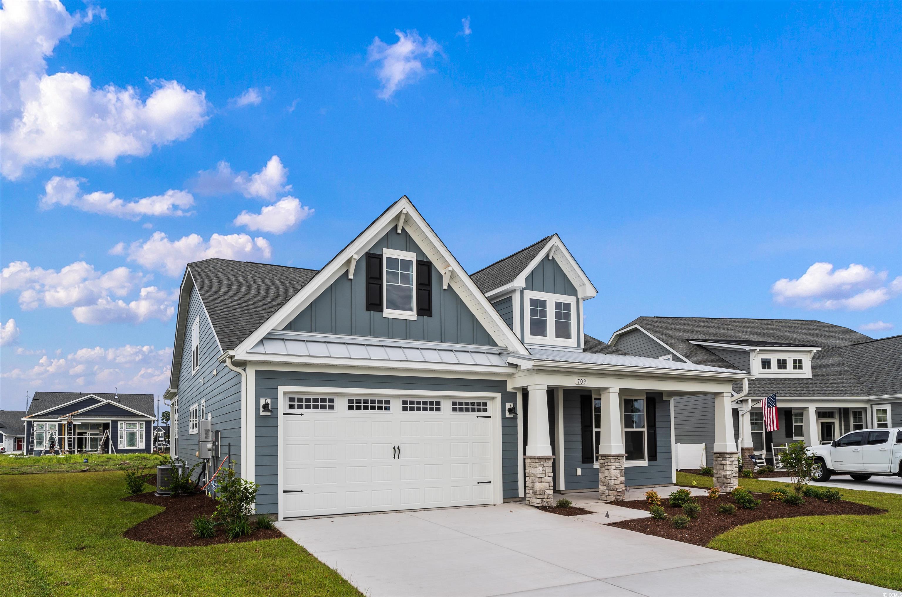 709 Lapwind Loop Myrtle Beach, SC 29579 - Photo 3 of 15 Craftsman-style house with cooling unit, a front y