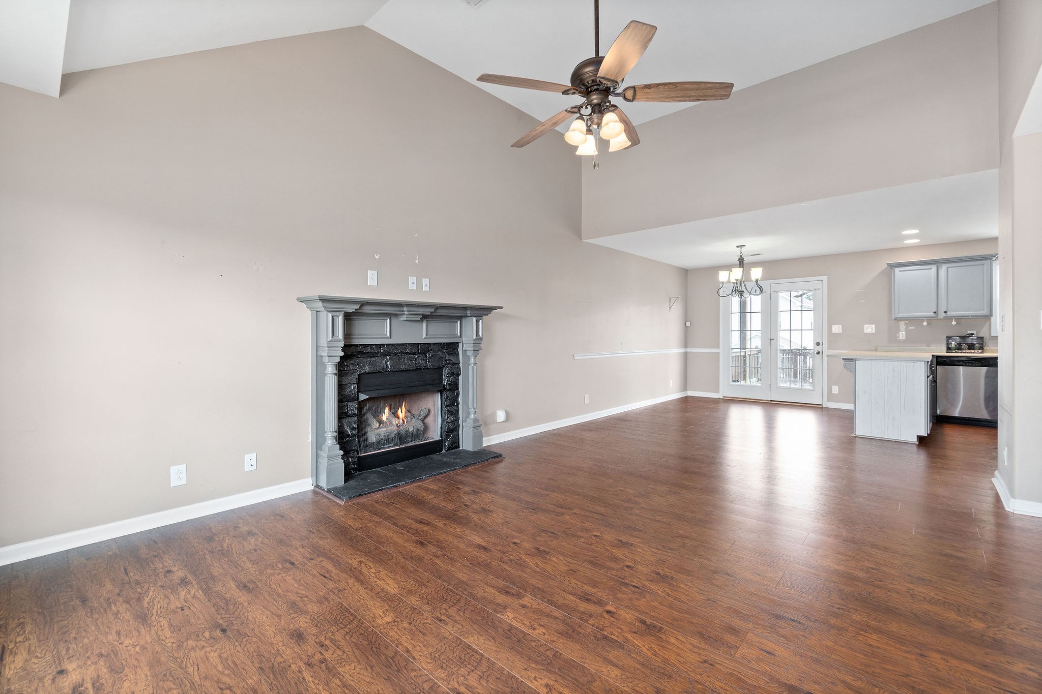 3795 Suiter Road Clarksville, TN 37040 - Photo 9 of 33 a view of an empty room with wooden floor fireplace and a window