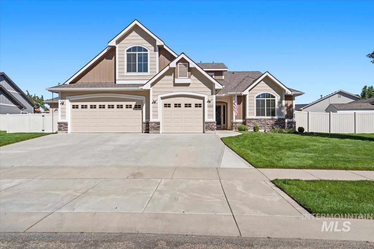 1183 North Buffalo Way Middleton, ID 83644 - Photo 5 of 47 Spacious two-story residence featuring a three-car garage, stone accents, arched windows, and a manicured front lawn