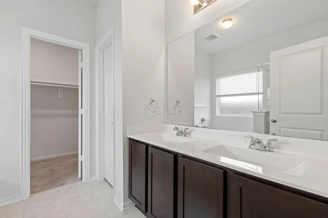 a bathroom with a sink double vanity and a mirror