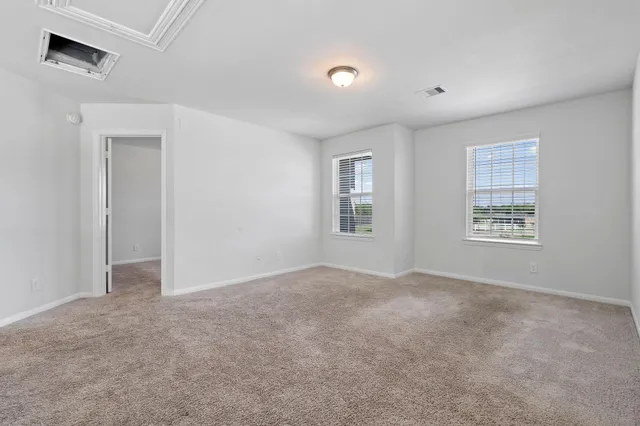 an empty room with windows and closet