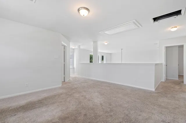 an empty room with a kitchen and a sink