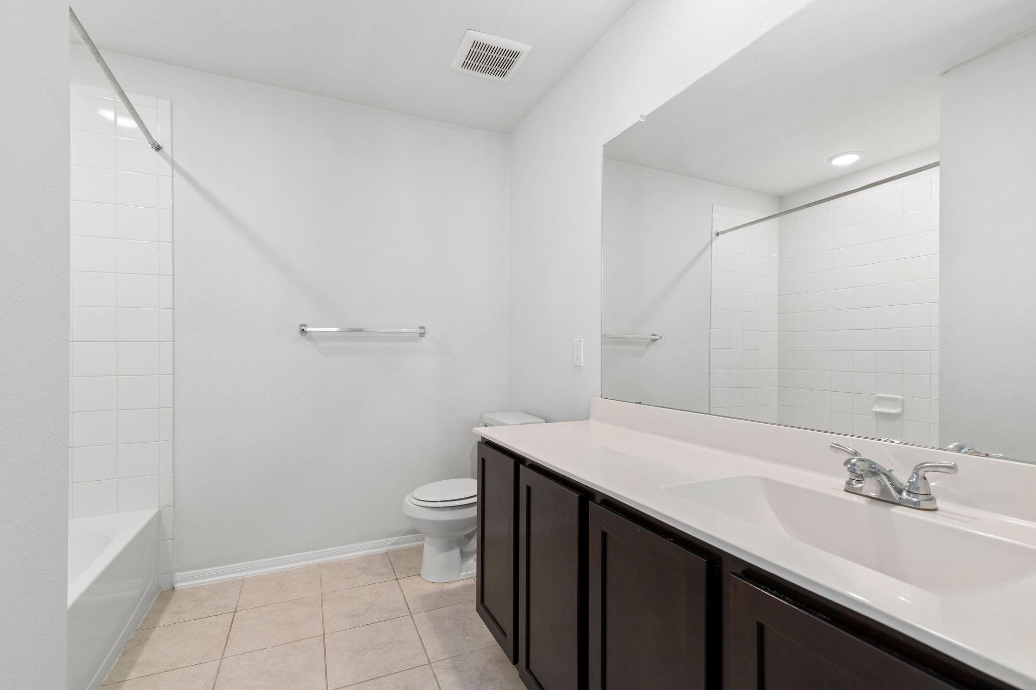 5319 Rivers Edge Drive Richmond, TX 77469 - Photo 20 of 23 a bathroom with a sink a toilet and a mirror