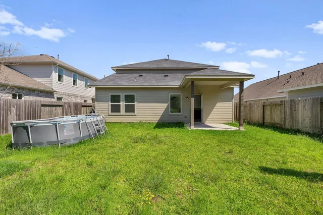 a view of a house with a yard and sitting area