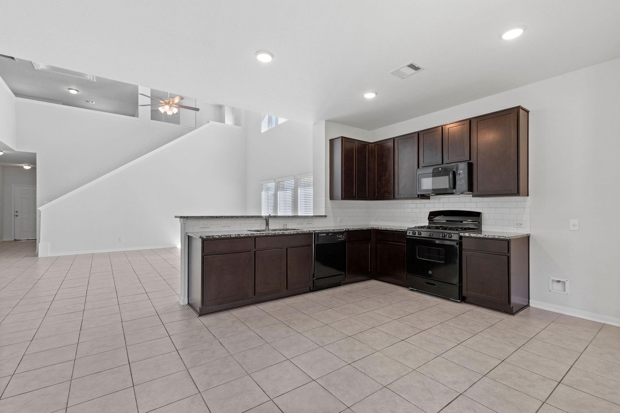 5319 Rivers Edge Drive Richmond, TX 77469 - Photo 6 of 23 a kitchen with stainless steel appliances granite countertop a refrigerator and a sink
