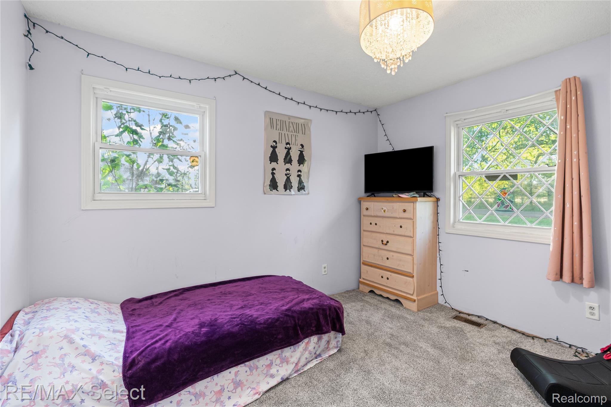 6393 East Frances Road Mount Morris, MI 48458 - Photo 22 of 37 Bedroom with light carpet and a chandelier