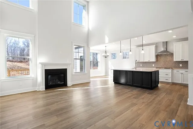 a living room with furniture a wooden floor and a fireplace