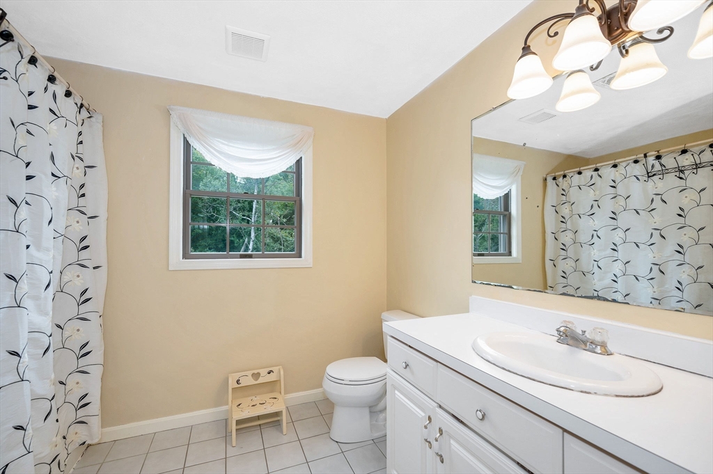 24 Andrews Farm Road Boxford, MA 01921 - Photo 19 of 26 a bathroom with a granite countertop sink a toilet and a mirror