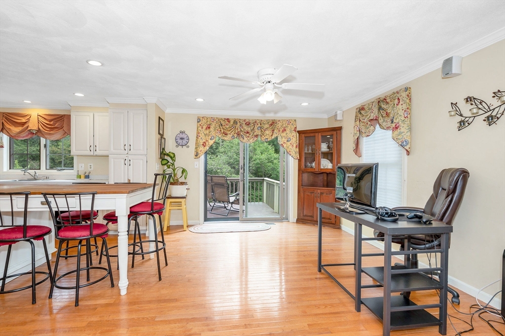 24 Andrews Farm Road Boxford, MA 01921 - Photo 8 of 26 a living room with furniture a flat screen tv and a floor to ceiling window