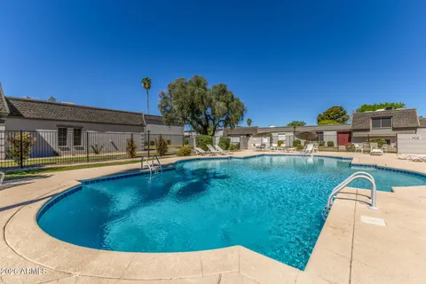 a swimming pool with outdoor seating yard and barbeque oven