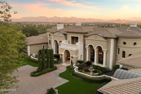 a front view of a house with a garden and yard