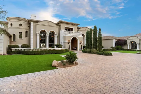 a view of a dining room with furniture a chandelier and wooden floor