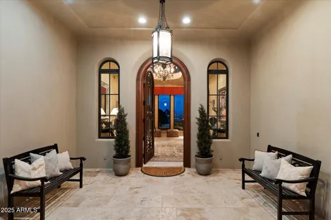 a living room with furniture fireplace and a large window
