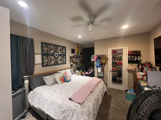 a bedroom with a bed and a large mirror