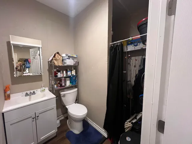 a bathroom with a toilet a sink and a mirror
