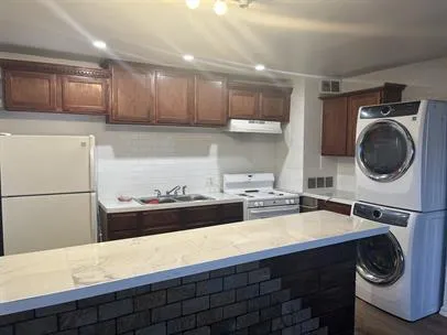 a kitchen with a sink a stove and cabinets