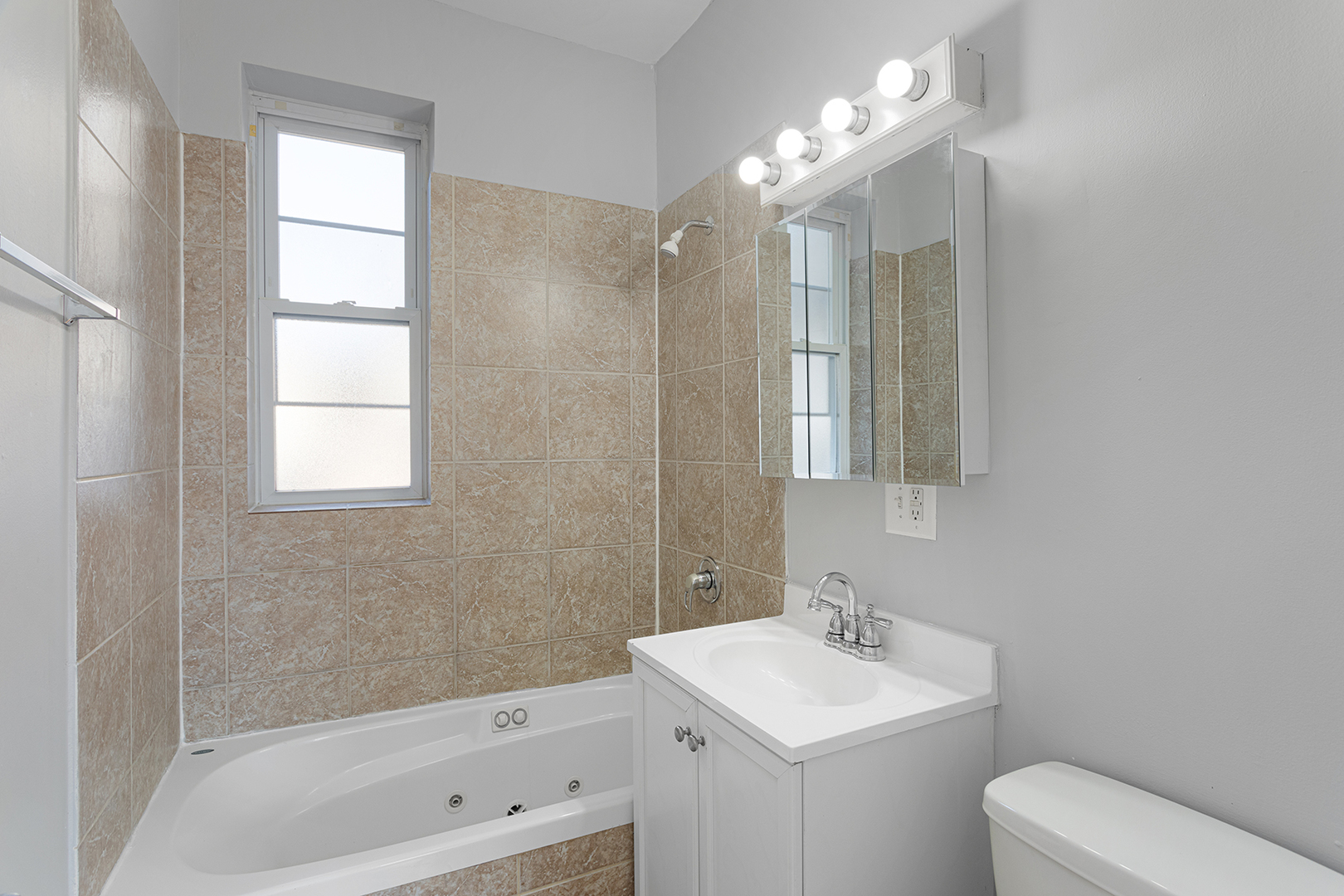 7328 North Damen Avenue, Unit 3 Chicago, IL 60645 - Photo 11 of 14 a bathroom with a sink a toilet and shower