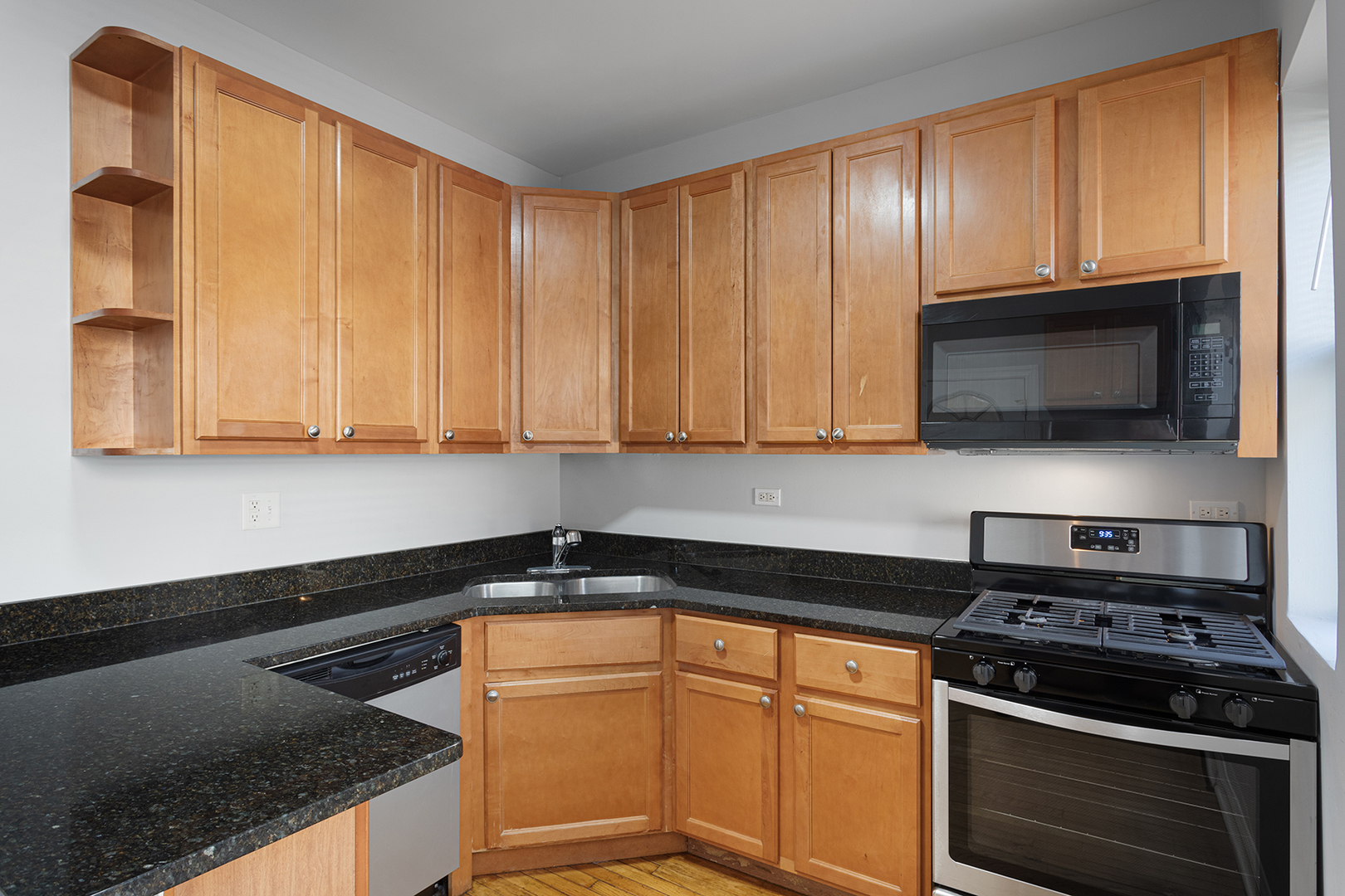 7328 North Damen Avenue, Unit 3 Chicago, IL 60645 - Photo 3 of 14 a kitchen with wooden cabinets and a stove top oven