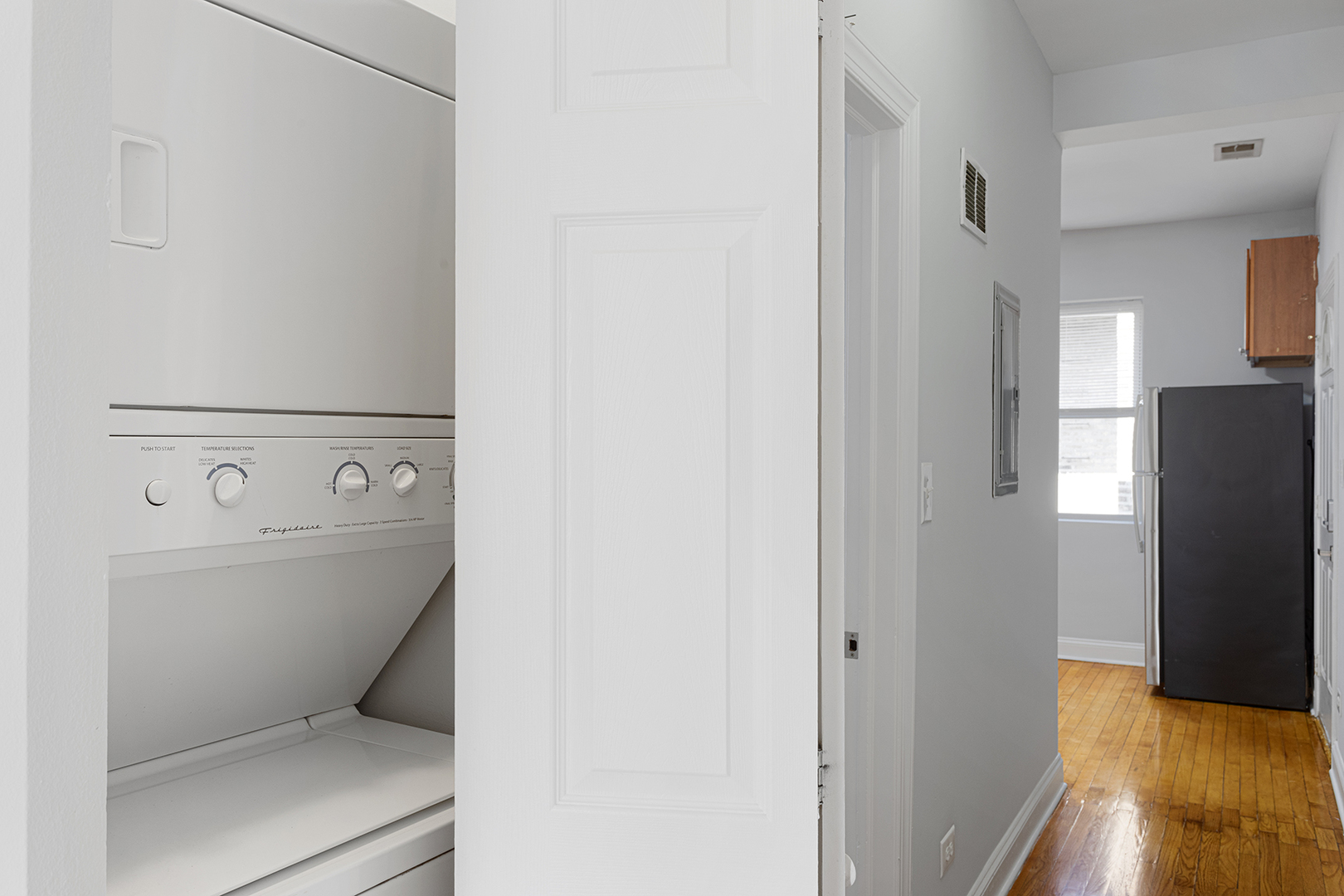 7328 North Damen Avenue, Unit 3 Chicago, IL 60645 - Photo 8 of 14 a view of washer and dryer with wooden floor