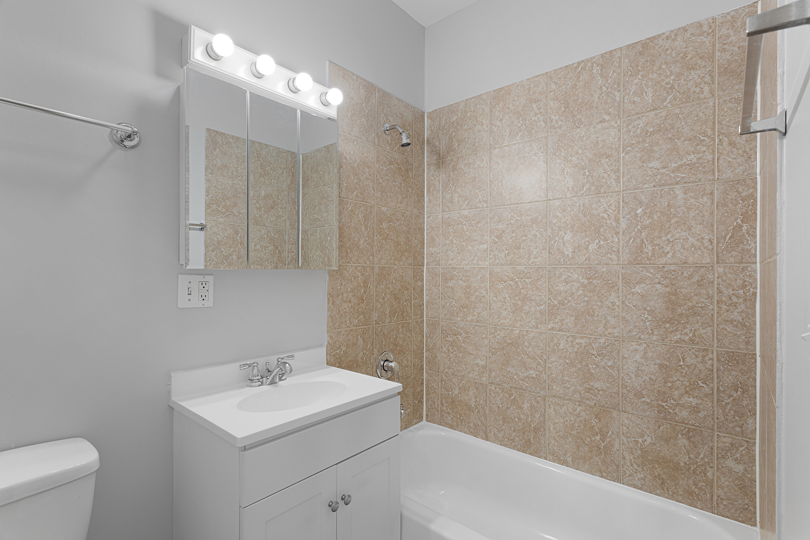 7328 North Damen Avenue, Unit 3 Chicago, IL 60645 - Photo 10 of 14 a bathroom with a sink a toilet and shower